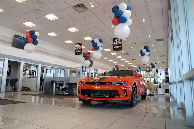 Showroom with red car on display